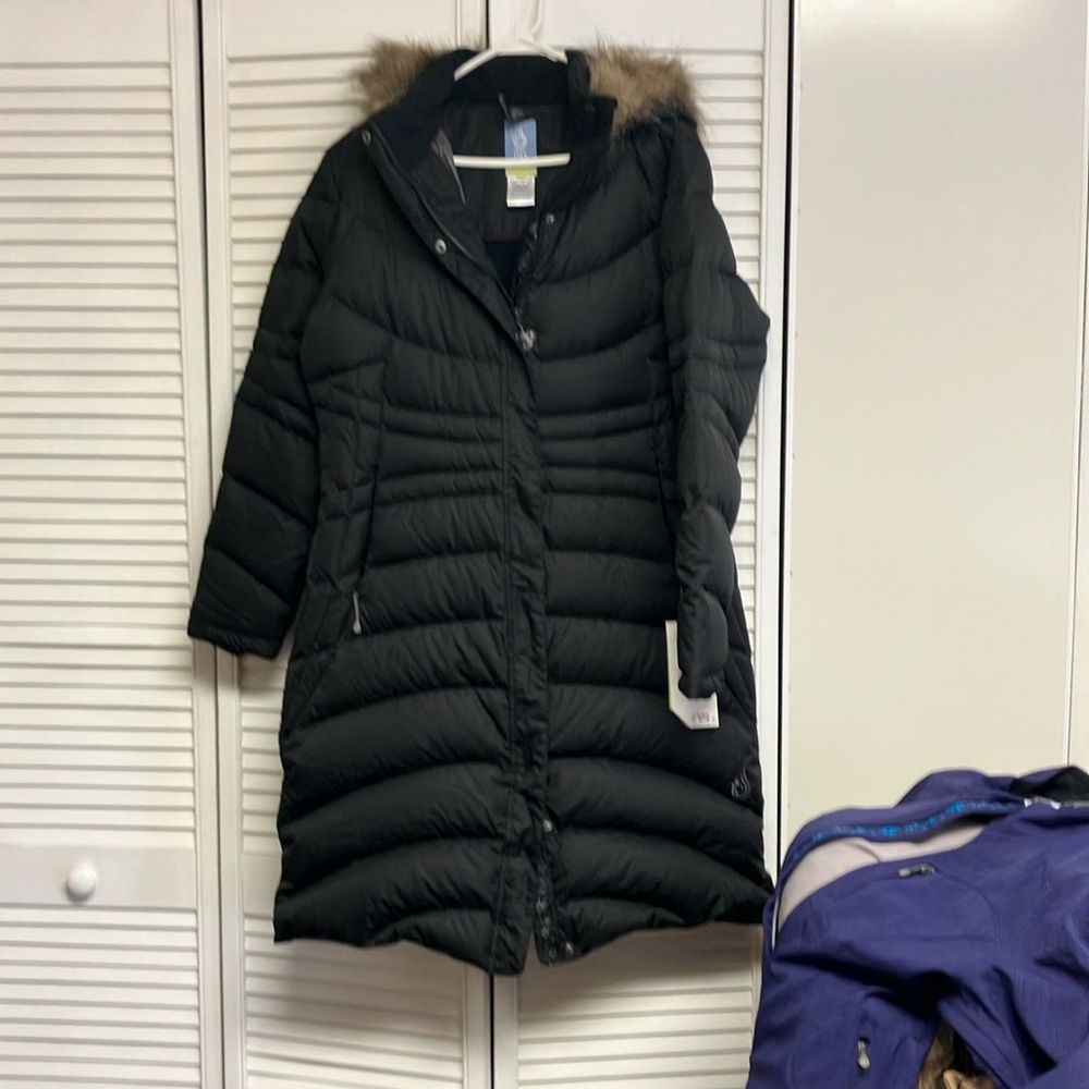 Winter coat. Down filled. Hooded. Many pockets inside.